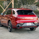 The rear of a Genesis GV70 in red.